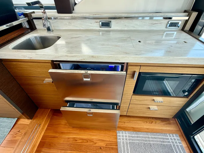  Yacht Photos Pics Modern kitchen area in 2017 Tiara Yachts C44 Coupe with stainless steel appliances.