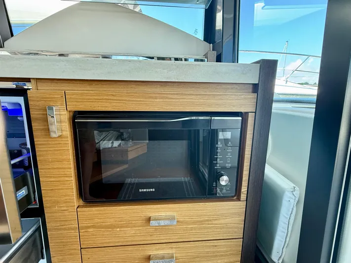  Yacht Photos Pics Microwave in 2017 Tiara Yachts C44 Coupe kitchen with wooden cabinetry.