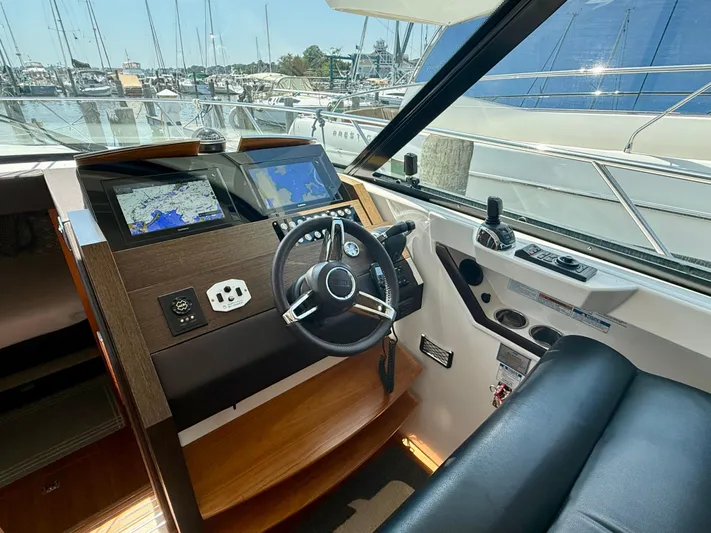  Yacht Photos Pics Helm of 2017 Tiara Yachts C44 Coupe with navigation screens and steering wheel.