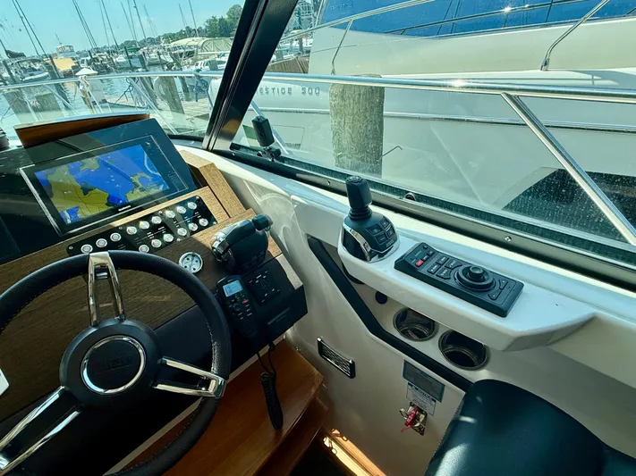  Yacht Photos Pics Helm of 2017 Tiara Yachts C44 Coupe with navigation controls and display.