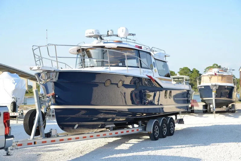  Yacht Photos Pics 2026 Ranger Tugs R-29 S boat on a trailer, parked outdoors.