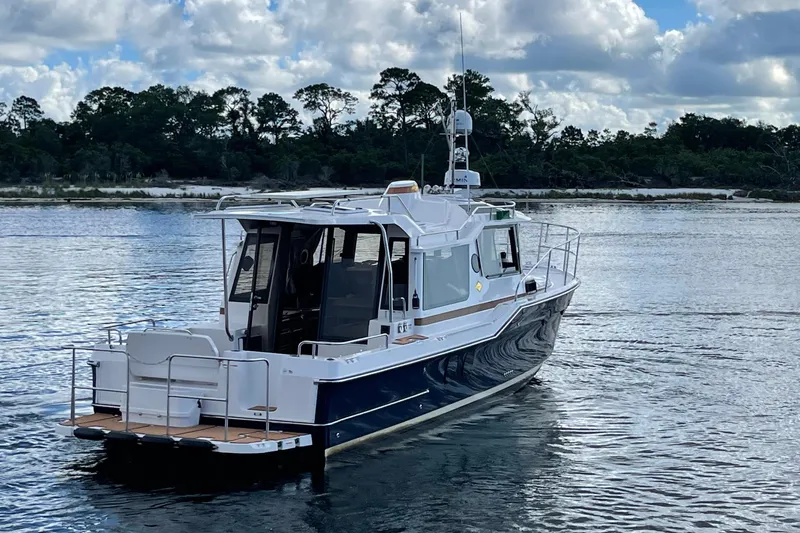  Yacht Photos Pics 2026 Ranger Tugs R-29 S boat on calm water with scenic background.