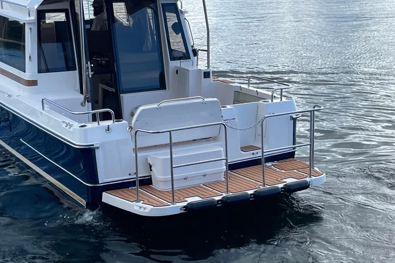  Yacht Photos Pics 2026 Ranger Tugs R-29 S boat, rear view, on calm water.