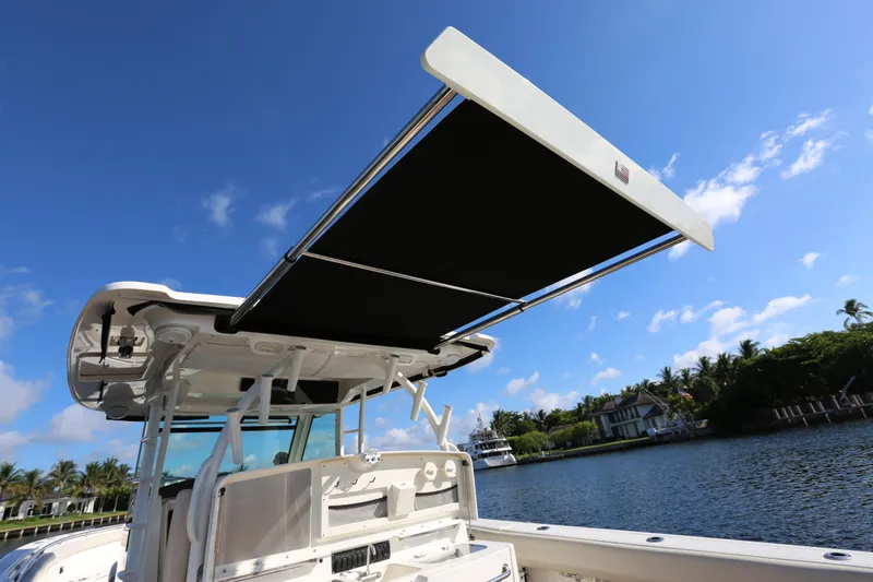  Yacht Photos Pics 2017 Boston Whaler 370 Outrage boat with extended sunshade on a sunny day.
