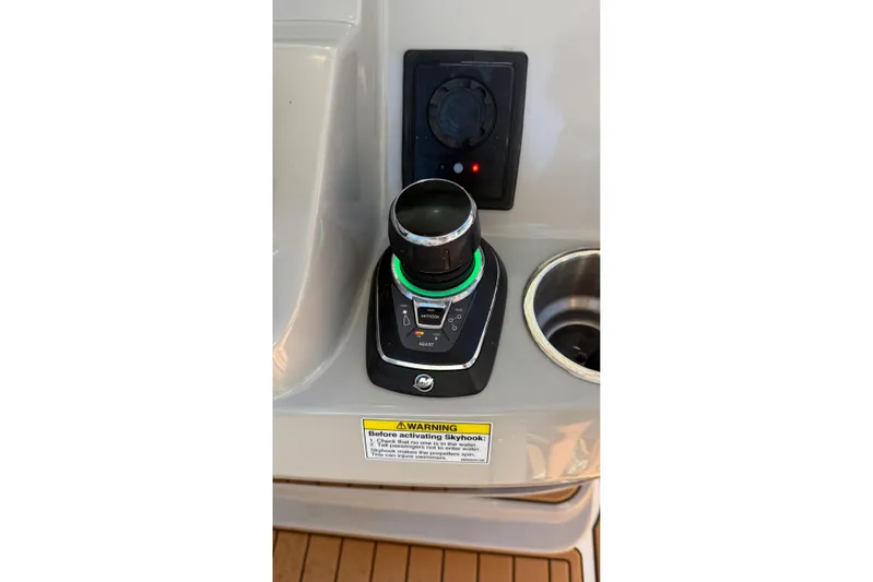 Yacht Photos Pics Control panel of a 2017 Boston Whaler 370 Outrage boat with joystick and warning label.