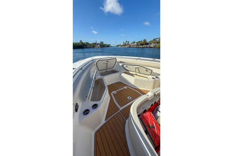  Yacht Photos Pics 2017 Boston Whaler 370 Outrage boat interior with teak flooring and open storage compartments.