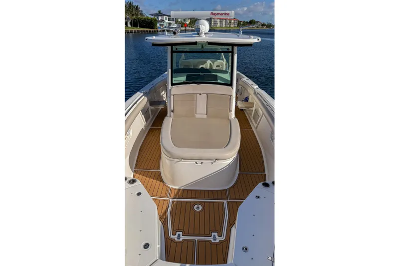  Yacht Photos Pics 2017 Boston Whaler 370 Outrage boat with teak deck, docked on calm water.