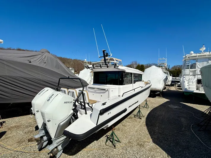  Yacht Photos Pics 2021 Axopar 37 boat with twin Mercury engines, parked outdoors under clear blue sky.