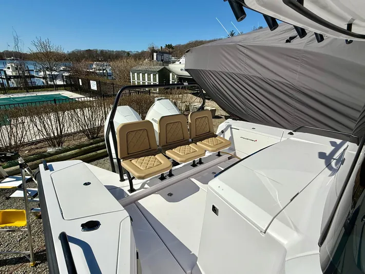  Yacht Photos Pics 2021 Axopar 37 boat with beige seating, docked near a pool and marina.