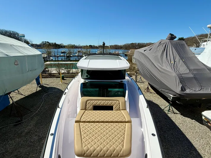  Yacht Photos Pics 2021 Axopar 37 boat docked, featuring a sleek design and spacious seating area.