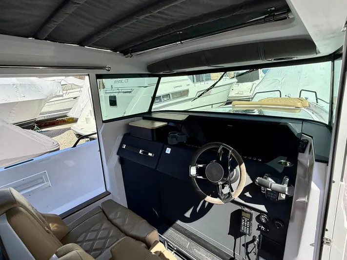  Yacht Photos Pics Interior of a 2021 Axopar 37 boat, featuring a modern steering console.