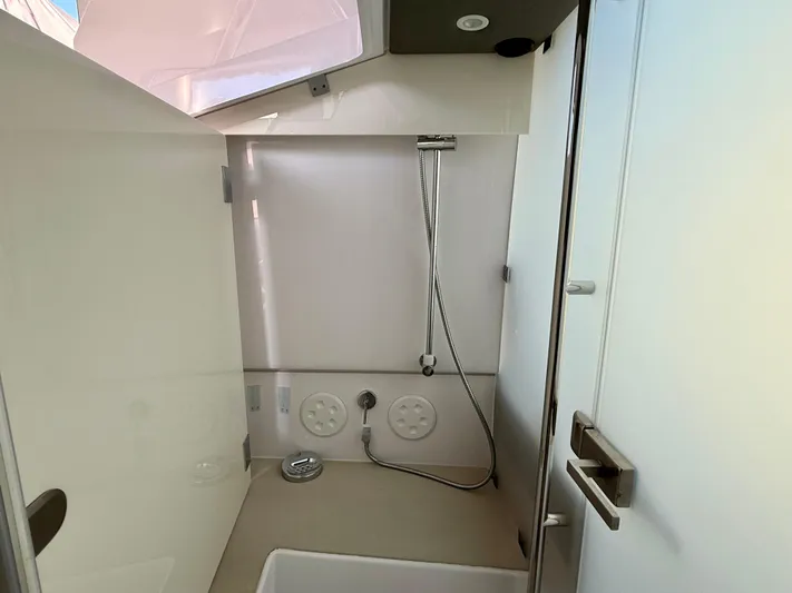  Yacht Photos Pics Interior view of 2021 Axopar 37 boat bathroom with shower and modern fixtures.