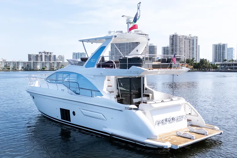 Andromeda Yacht Photos Pics 2023 Azimut Fly 50 yacht on water with city skyline backdrop.