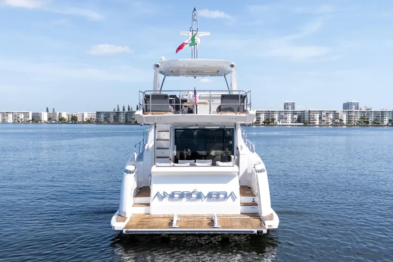 Andromeda Yacht Photos Pics 2023 Azimut Fly 50 yacht on calm water, cityscape in background.