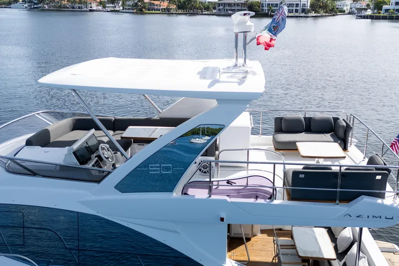 Andromeda Yacht Photos Pics 2023 Azimut Fly 50 yacht with spacious deck and modern design on a serene waterway.