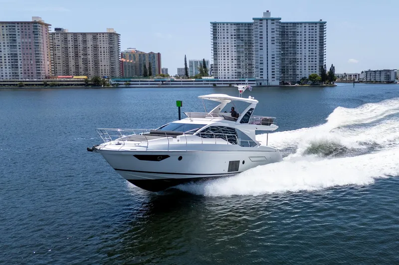 Andromeda Yacht Photos Pics 2023 Azimut Fly 50 yacht cruising on a city waterfront.