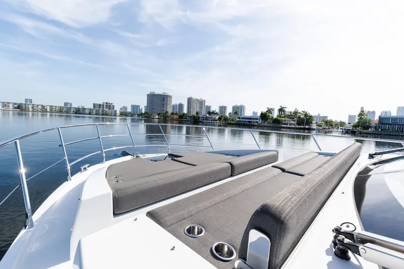 Andromeda Yacht Photos Pics Luxurious 2023 Azimut Fly 50 yacht with spacious deck, city skyline in background.