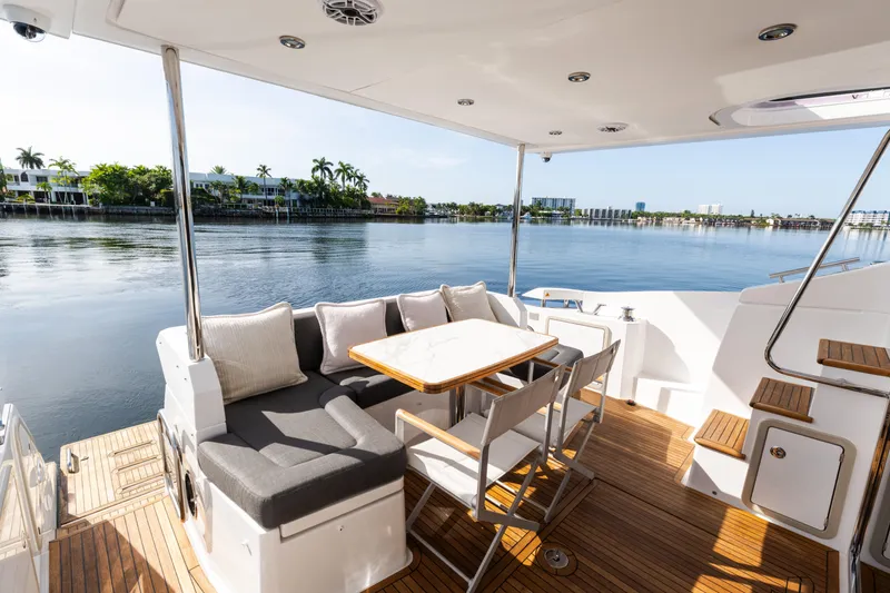 Andromeda Yacht Photos Pics Luxurious 2023 Azimut Fly 50 yacht deck with seating, overlooking serene waterfront views.