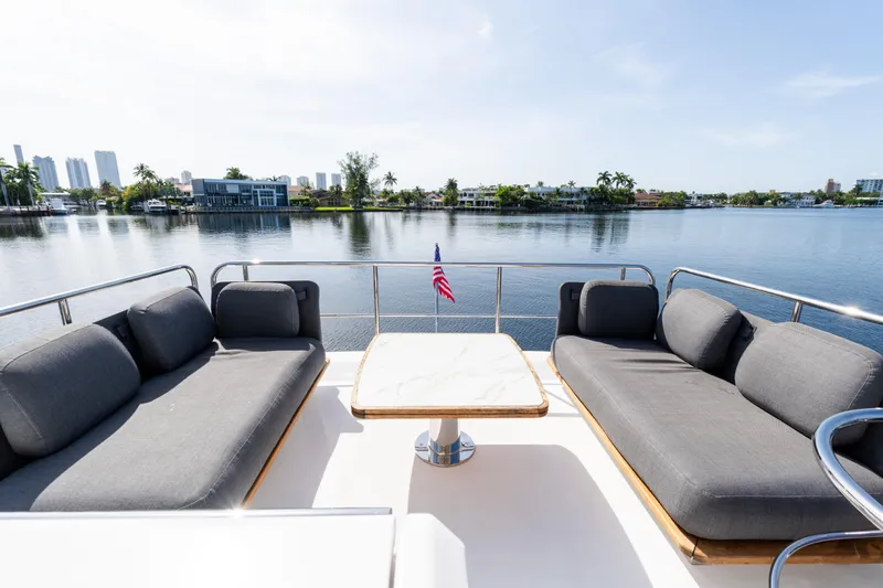 Andromeda Yacht Photos Pics Luxurious 2023 Azimut Fly 50 yacht deck with elegant seating and scenic waterfront view.