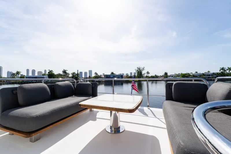 Andromeda Yacht Photos Pics Luxurious 2023 Azimut Fly 50 yacht deck with elegant seating and scenic waterfront view.