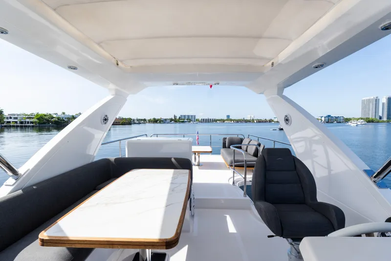Andromeda Yacht Photos Pics Luxurious 2023 Azimut Fly 50 yacht interior with elegant seating and scenic waterfront view.