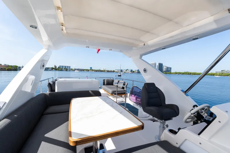 Andromeda Yacht Photos Pics 2023 Azimut Fly 50 yacht interior with luxurious seating and scenic waterfront view.