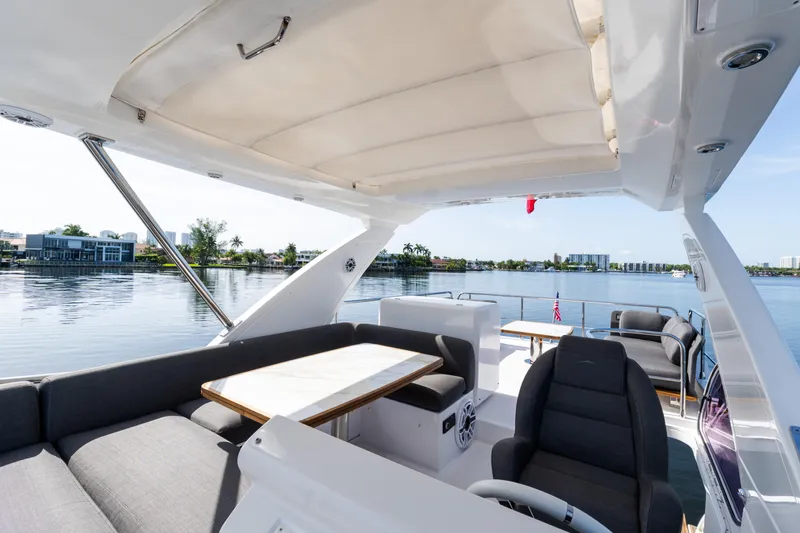 Andromeda Yacht Photos Pics Luxurious 2023 Azimut Fly 50 yacht interior with elegant seating and scenic waterfront view.