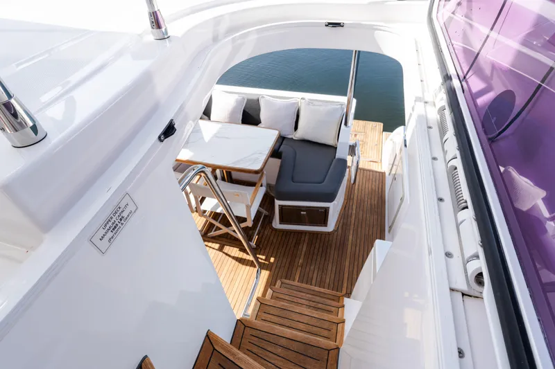 Andromeda Yacht Photos Pics 2023 Azimut Fly 50 yacht with elegant wooden deck and comfortable seating area.