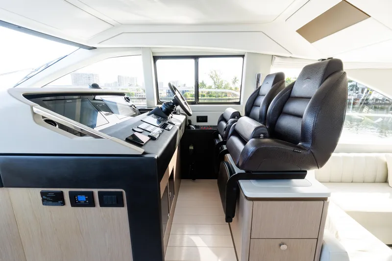 Andromeda Yacht Photos Pics Luxurious interior of 2023 Azimut Fly 50 yacht with modern helm and leather seating.