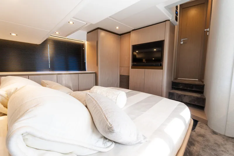 Andromeda Yacht Photos Pics Luxurious bedroom interior of 2023 Azimut Fly 50 yacht, featuring modern design and cozy bedding.