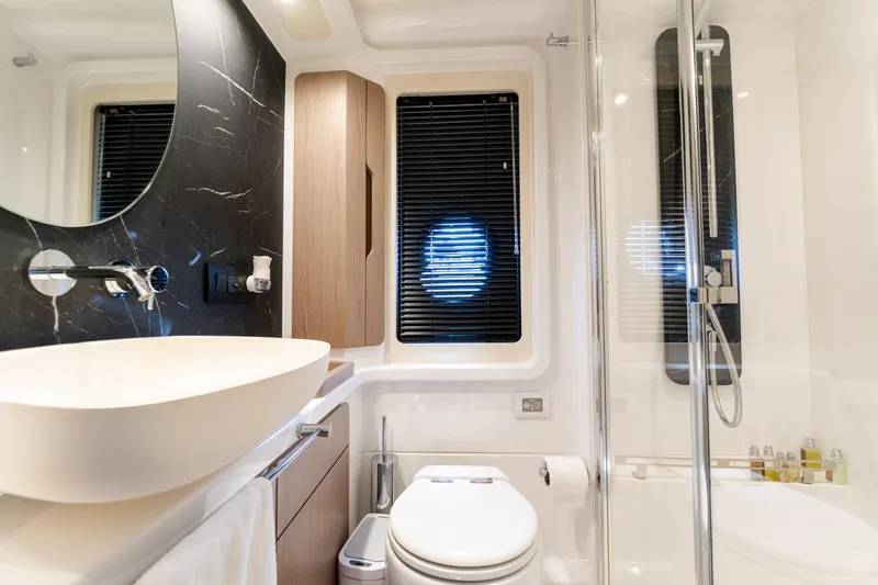 Andromeda Yacht Photos Pics Luxurious bathroom in 2023 Azimut Fly 50 yacht with modern fixtures and elegant design.