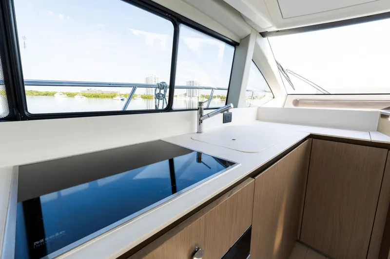 Andromeda Yacht Photos Pics Modern kitchen interior on 2023 Azimut Fly 50 yacht, featuring sleek design and scenic window view.