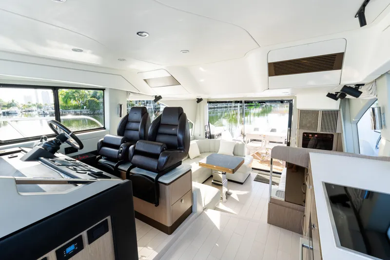 Andromeda Yacht Photos Pics Luxurious interior of 2023 Azimut Fly 50 yacht with modern seating and panoramic windows.