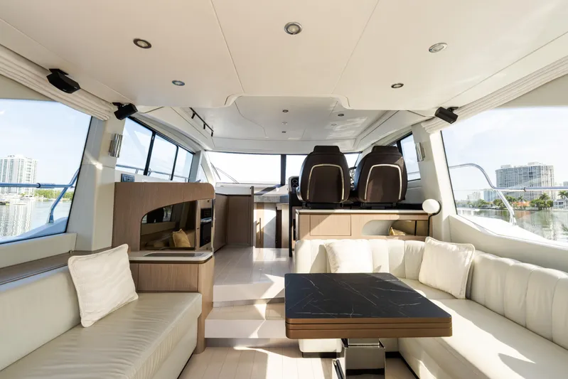 Andromeda Yacht Photos Pics Luxurious interior of 2023 Azimut Fly 50 yacht with modern seating and panoramic windows.