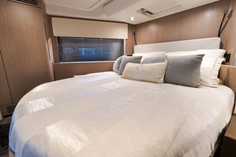 Andromeda Yacht Photos Pics Luxurious bedroom interior of 2023 Azimut Fly 50 yacht with elegant bedding and modern design.