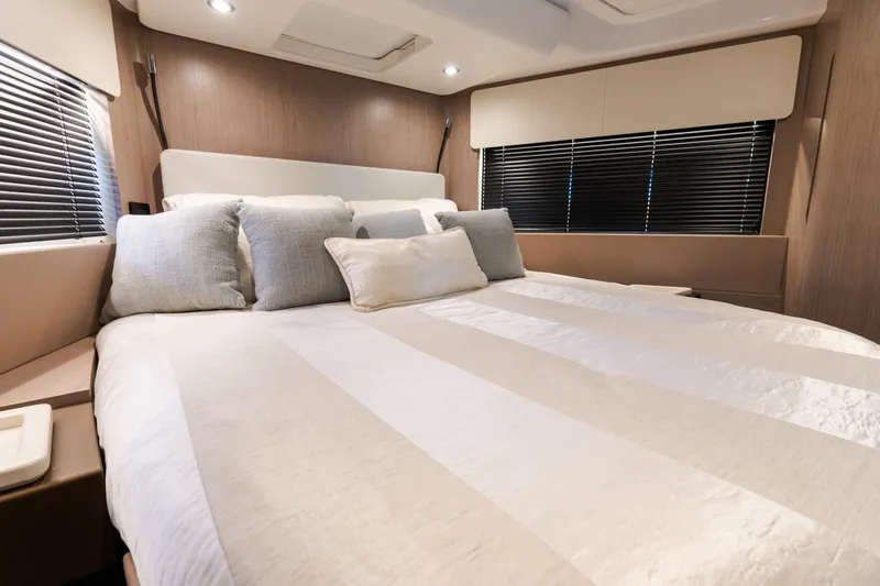 Andromeda Yacht Photos Pics Luxurious bedroom interior of 2023 Azimut Fly 50 yacht with elegant bedding and modern design.
