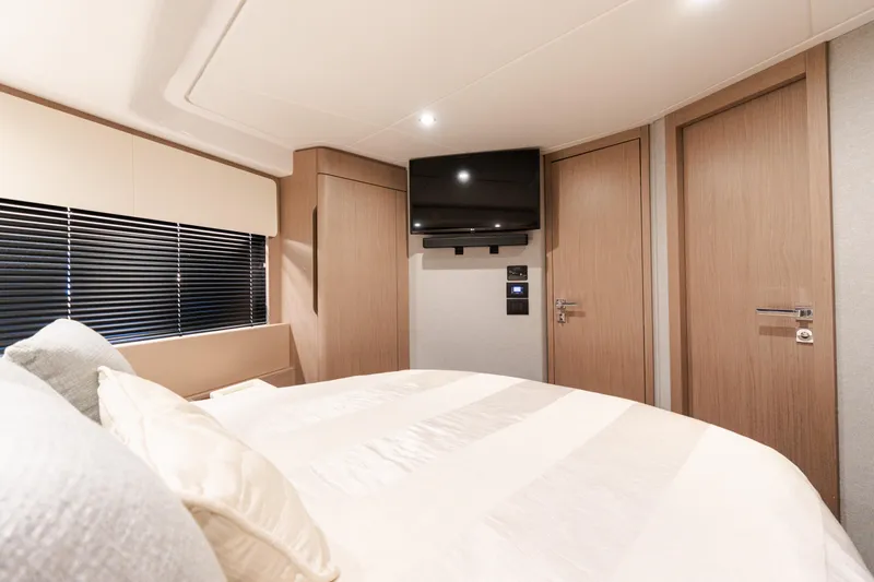 Andromeda Yacht Photos Pics Luxurious bedroom interior of 2023 Azimut Fly 50 yacht with modern design and TV.