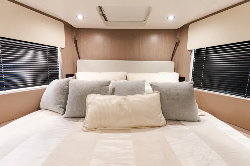 Andromeda Yacht Photos Pics Luxurious bedroom interior of 2023 Azimut Fly 50 yacht with plush pillows and modern design.