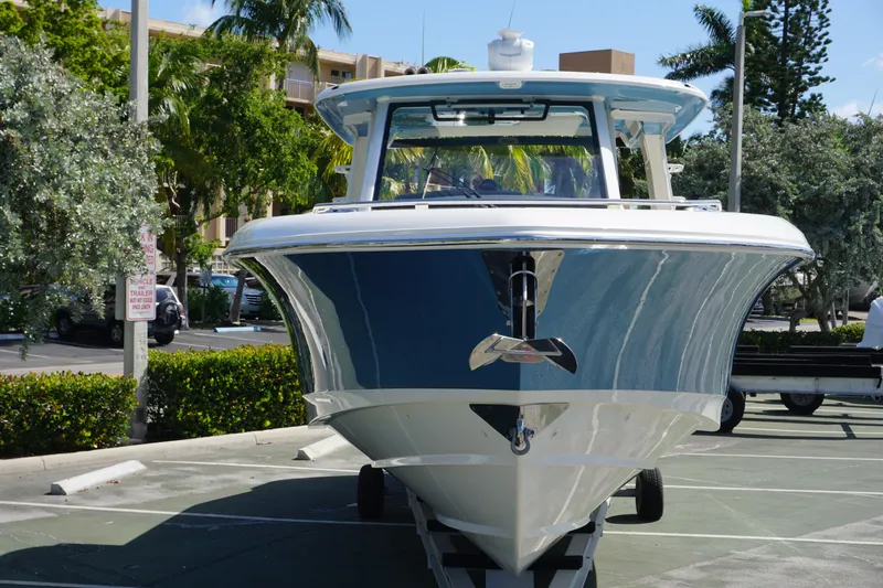 Bwce0015f324 Yacht Photos Pics 2024 Boston Whaler 350 Realm boat front view in a parking lot.