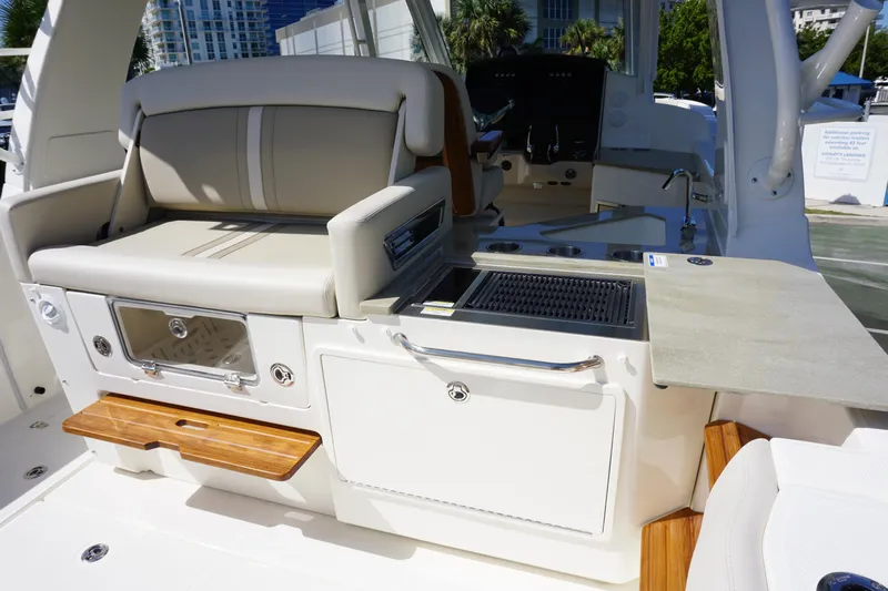 Bwce0015f324 Yacht Photos Pics 2024 Boston Whaler 350 Realm boat interior with seating and grill station.
