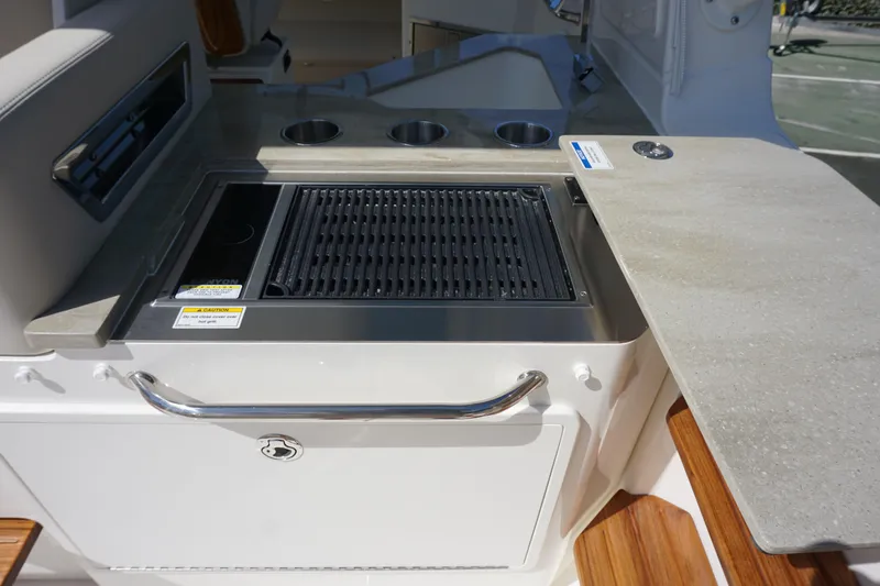 Bwce0015f324 Yacht Photos Pics Outdoor kitchen on 2024 Boston Whaler 350 Realm boat with grill and counter space.