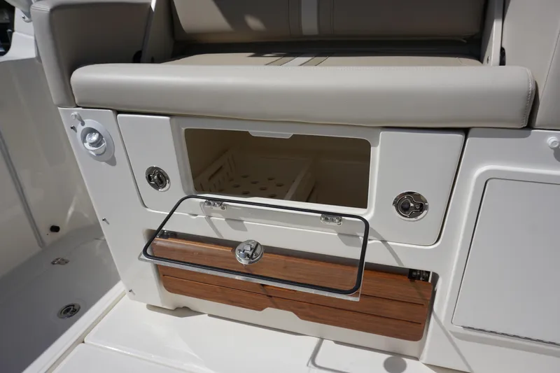 Bwce0015f324 Yacht Photos Pics 2024 Boston Whaler 350 Realm boat storage compartment with cushioned seating.