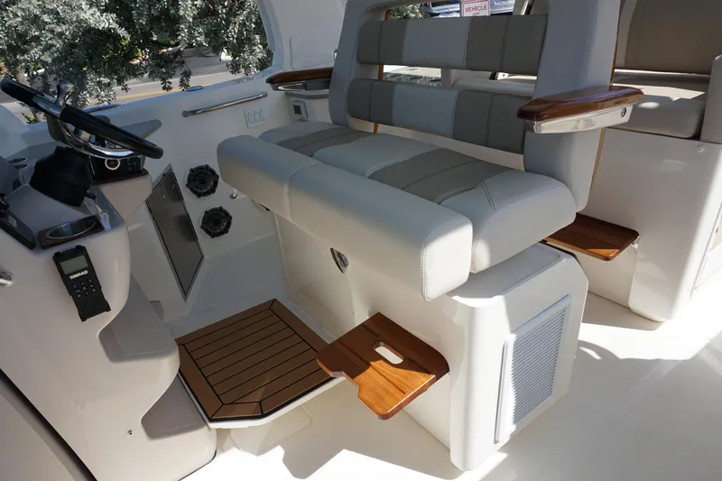 Bwce0015f324 Yacht Photos Pics 2024 Boston Whaler 350 Realm helm seating area with luxurious upholstery and wooden accents.