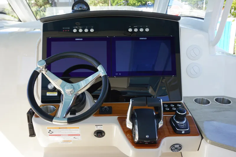 Bwce0015f324 Yacht Photos Pics 2024 Boston Whaler 350 Realm helm with dual Simrad displays and modern controls.