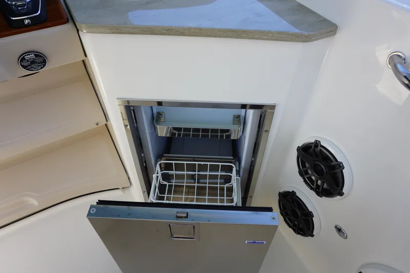 Bwce0015f324 Yacht Photos Pics 2024 Boston Whaler 350 Realm boat interior with open refrigerator and speakers.