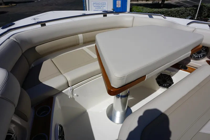 Bwce0015f324 Yacht Photos Pics 2024 Boston Whaler 350 Realm boat interior with cushioned seating and table.