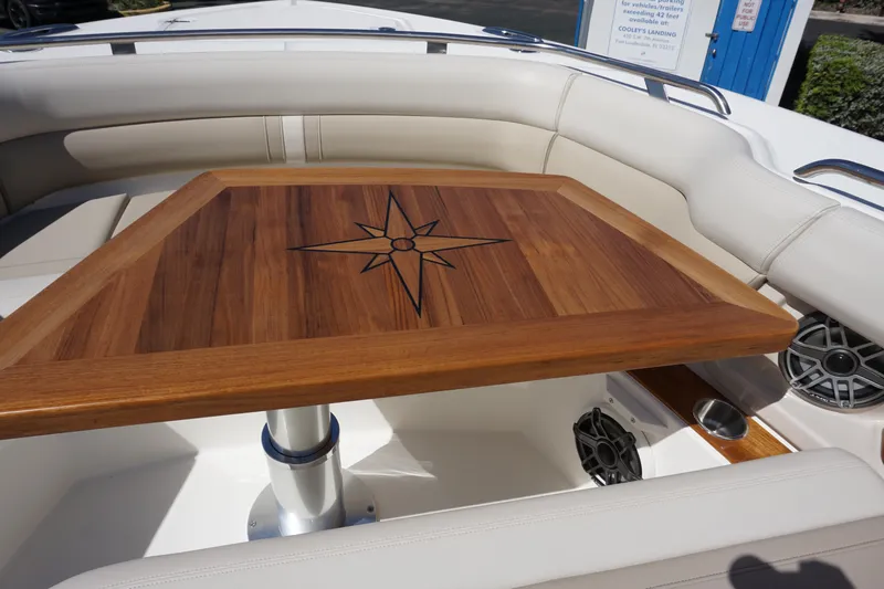 Bwce0015f324 Yacht Photos Pics Boston Whaler 350 Realm 2024 boat with elegant wooden table and cushioned seating.