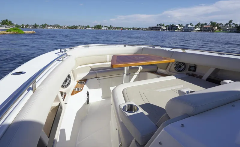 Bwce0015f324 Yacht Photos Pics 2024 Boston Whaler 350 Realm boat interior with seating and table on a sunny day.