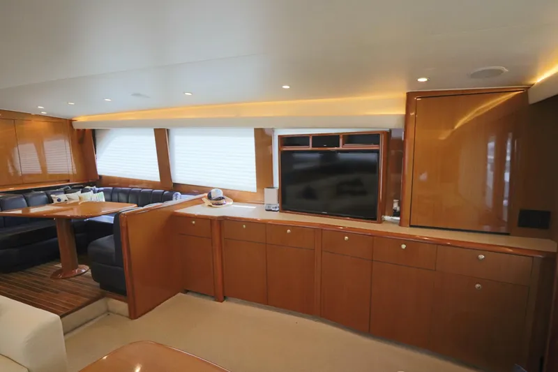 Angie Yacht Photos Pics Luxurious interior of a 2000 Viking 65 yacht with wood cabinetry and seating area.