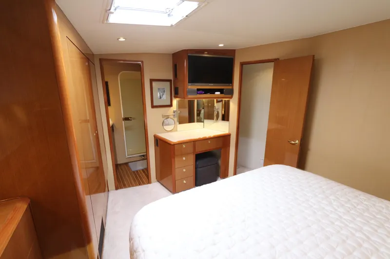 Angie Yacht Photos Pics Luxurious bedroom interior of a 2000 Viking 65 yacht with modern amenities.